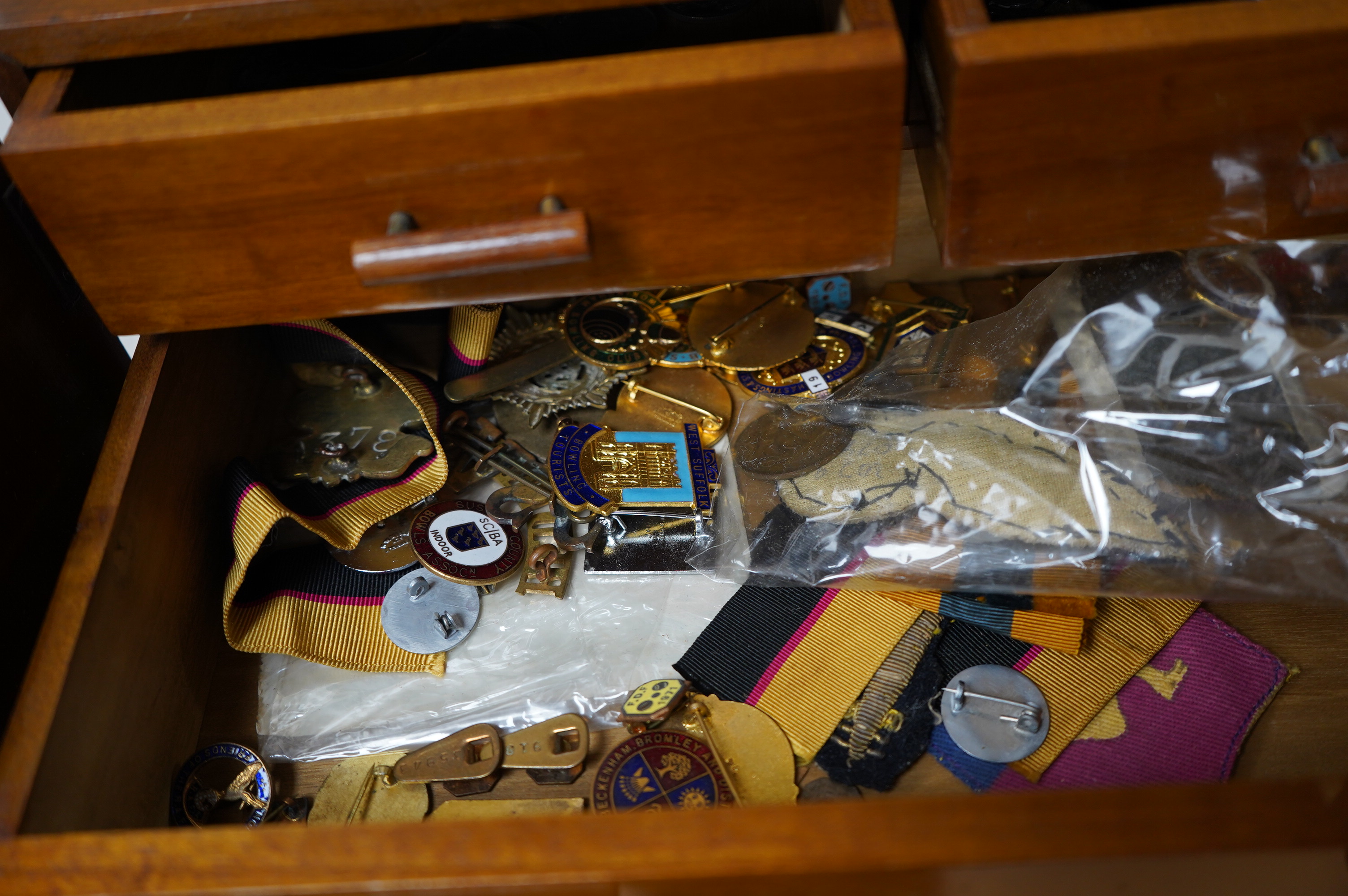 Coins, medals, medallions and badges, mainly 20th century British and European issue contained within a wooden cabinet, together with three leather boxes with padddd and lined interiors. Condition - fair.